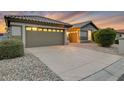 Front view of a house with a two-car garage and driveway at 14861 W Verde Ln, Goodyear, AZ 85395