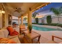 Inviting backyard oasis featuring a refreshing pool and relaxing patio furniture at 14861 W Verde Ln, Goodyear, AZ 85395