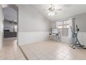 Bright dining room with tile floors and a view into the living room at 15268 W Melissa Ln, Surprise, AZ 85374