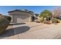 House exterior featuring a front yard with drought-tolerant landscaping at 15268 W Melissa Ln, Surprise, AZ 85374