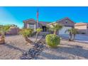 Charming curb appeal with a rock pathway, lush landscaping, and a three-car garage at 16351 W Yucatan Dr, Surprise, AZ 85388