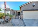 Front entry with a brick walkway and iron gate at 16351 W Yucatan Dr, Surprise, AZ 85388