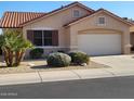 Tan one-story house with tile roof, two-car garage, and desert landscaping at 17449 N Fairway Dr, Surprise, AZ 85374