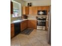 Kitchen with wood cabinets, stainless steel appliances, and tile flooring at 17449 N Fairway Dr, Surprise, AZ 85374