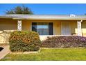 Bright yellow ranch home with nicely landscaped yard at 19002 N Signal Butte Cir, Sun City, AZ 85373