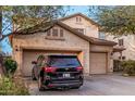 Charming two-story home with a three-car garage and a long concrete driveway at 19308 W Jefferson St, Buckeye, AZ 85326