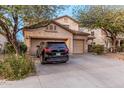 Charming two-story home with a three-car garage and a long concrete driveway at 19308 W Jefferson St, Buckeye, AZ 85326