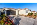 Front view of a single story home with desert landscaping and a two car garage at 19756 W Roma Ave, Litchfield Park, AZ 85340