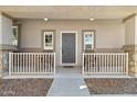 Front porch with two chairs and a gray door at 2212 E Sunland Ave, Phoenix, AZ 85040