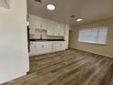 White kitchen cabinets and dark countertops at 2611 N 40Th Ave, Phoenix, AZ 85009