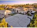 An aerial view of a residence with a pool, sport court, and extensive landscaping at 2916 E Arrowhead Trl, Gilbert, AZ 85297