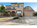 Charming two-story home featuring a tile roof, desert landscaping, and a two-car garage at 3115 E Turnberry Dr, Gilbert, AZ 85298