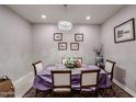 Formal dining room with a table set for six and hardwood floors at 3134 E Sunrise Pl, Chandler, AZ 85286