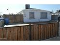 Ranch style home with wood gate and small front yard at 3215 W Garfield St, Phoenix, AZ 85009