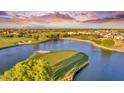 Aerial view of a luxury golf course community with lake and homes at 3374 E Virgil Dr, Gilbert, AZ 85298