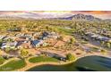 Aerial view showcasing a luxurious community near a golf course and lake at 3374 E Virgil Dr, Gilbert, AZ 85298