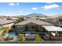 Gorgeous backyard featuring a sparkling pool and spa, artificial grass, and mountain views in the distance at 3374 E Virgil Dr, Gilbert, AZ 85298