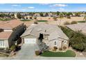 Stunning home with a neutral color palette, stone accents, and a well-manicured lawn next to a golf course at 3374 E Virgil Dr, Gilbert, AZ 85298