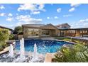 Inviting pool featuring decorative fountains, mature landscaping, and an outdoor seating area at 3374 E Virgil Dr, Gilbert, AZ 85298