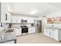 Bright kitchen features white cabinets, stainless steel appliances, and granite countertops at 3410 E Everett Dr, Phoenix, AZ 85032