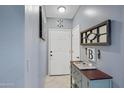 Bright entryway with a console table, mirror, and wall art at 3510 E Hampton Ave # 3, Mesa, AZ 85204