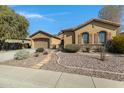 Charming home with a well-manicured, low-maintenance front yard and a stone walkway at 40325 N Graham Way, Anthem, AZ 85086