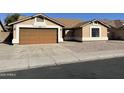 Charming single-story home featuring a two-car garage and a well-maintained concrete driveway at 4130 W Chama Dr, Glendale, AZ 85310