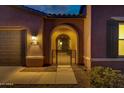 Elegant entryway with wrought iron gate leading to the front door at 41929 W Springtime Rd, Maricopa, AZ 85138