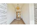 Inviting entryway with designer lighting fixture and glass-paneled front door at 4201 N 18Th Pl, Phoenix, AZ 85016