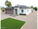 Stylish single-story home featuring a neutral color palette, manicured gravel yard and brick driveway at 4201 N 18Th Pl, Phoenix, AZ 85016