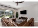 Spacious living room featuring a brown leather sectional sofa and large TV at 4765 S Pluto --, Mesa, AZ 85212