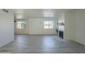 Spacious living area with gray laminate floors and a fireplace at 5115 N 22Nd Ave # 1, Phoenix, AZ 85015