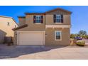 Tan two-story house with attached garage and a neatly landscaped front yard at 5172 E Desert Forest Trl, Cave Creek, AZ 85331