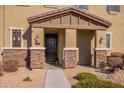 Front entrance with stone pillars, dark brown door, and a covered porch at 5172 E Desert Forest Trl, Cave Creek, AZ 85331