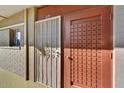 Condominium entry with security door and red door at 6125 E Indian School Rd # 218, Scottsdale, AZ 85251