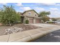 Two-story house with a two-car garage and nicely landscaped front yard at 629 E Palo Verde St, Casa Grande, AZ 85122