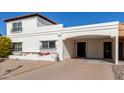 Front view of a charming Spanish-style home with carport at 7638 E Northland Dr, Scottsdale, AZ 85251