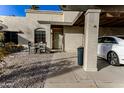 House exterior showcasing a covered patio area with seating and a car parked under at 7708 E Park View Dr Dr, Mesa, AZ 85208