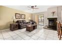 Living room with fireplace, tiled floors, and patio access at 9183 W Century Dr, Arizona City, AZ 85123