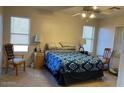 Cozy bedroom with two windows and neutral decor at 9841 E Forge Ave, Mesa, AZ 85208