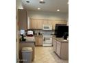 Bright kitchen with an island and stainless steel appliances at 9841 E Forge Ave, Mesa, AZ 85208