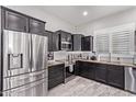 Modern kitchen with stainless steel appliances and granite countertops at 11957 W Daley Ln, Sun City, AZ 85373