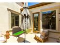 Charming back patio with seating area and pet-friendly turf at 1435 E Artemis Trl, Queen Creek, AZ 85140