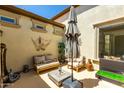 Relaxing back patio boasts comfortable seating and a large umbrella at 1435 E Artemis Trl, Queen Creek, AZ 85140