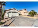 Two-story house with a two-car garage and desert landscaping at 15990 N 90Th Ave, Peoria, AZ 85382