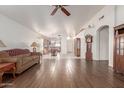 Spacious living room with hardwood floors and a view of the kitchen at 15990 N 90Th Ave, Peoria, AZ 85382