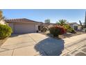 Front view of house, showing garage and driveway at 19751 N Desert Song Way, Surprise, AZ 85374