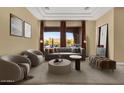 Bright living room featuring a large window with a scenic mountain view, stylish decor and recessed lighting at 19771 N 84Th Way, Scottsdale, AZ 85255