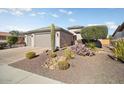 Neat front yard with drought-tolerant landscaping and a two-car garage at 26788 W Yukon Dr, Buckeye, AZ 85396