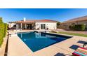 Inviting rectangular pool with a spacious backyard and lounge chairs at 2714 N 63Rd St, Mesa, AZ 85215